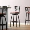 Lancaster Table & Seating Black Finish Cross Back Swivel Bar Stool With 2 1/2" Burgundy Vinyl Padded Seat