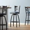 Lancaster Table & Seating Black Finish Cross Back Swivel Bar Stool With 2 1/2" Navy Vinyl Padded Seat
