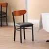 LT&S Boomerang Series Lancaster Table & Seating Boomerang Black Finish Chair With 2 1/2" Dark Brown Vinyl Padded Seat And Cherry Wood Back