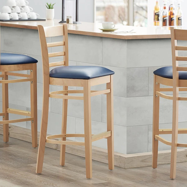Lancaster Table & Seating Natural Ladder Back Bar Height Chair With 2 1/2" Navy Padded Seat 1 Lancaster Table & Seating Natural Ladder Back Bar Height Chair With 2 1/2" Navy Padded Seat