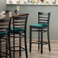 Lancaster Table & Seating Black Ladder Back Bar Height Chair With Green Padded Seat