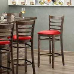 Lancaster Table & Seating Vintage Finish Ladder Back Bar Height Chair With Red Padded Seat