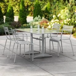 Lancaster Table & Seating 32" X 60" Silver Powder-Coated Aluminum Dining Height Outdoor Table With Umbrella Hole And 4 Arm Chairs
