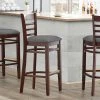 Lancaster Table & Seating Mahogany Finish Wooden Ladder Back Bar Height Chair With Dark Gray Padded Seat