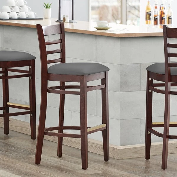 Lancaster Table & Seating Mahogany Finish Wooden Ladder Back Bar Height Chair With Dark Gray Padded Seat 1 Lancaster Table & Seating Mahogany Finish Wooden Ladder Back Bar Height Chair With Dark Gray Padded Seat