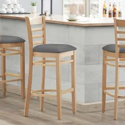 Lancaster Table & Seating Natural Finish Wooden Ladder Back Bar Height Chair With Dark Gray Padded Seat