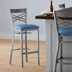 Lancaster Table & Seating Clear Coat Finish Cross Back Bar Stool With 2 1/2" Blue Vinyl Padded Seat