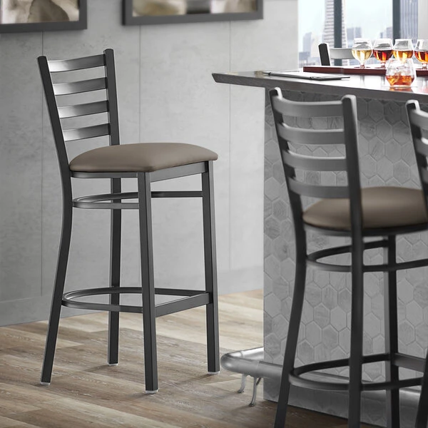 Lancaster Table & Seating Black Finish Ladder Back Bar Stool With 2 1/2" Taupe Vinyl Padded Seat 1 Lancaster Table & Seating Black Finish Ladder Back Bar Stool With 2 1/2" Taupe Vinyl Padded Seat