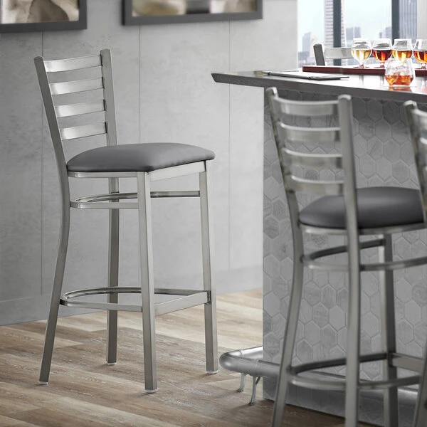 Lancaster Table & Seating Clear Coat Finish Ladder Back Bar Stool With 2 1/2" Dark Gray Vinyl Padded Seat 1 Lancaster Table & Seating Clear Coat Finish Ladder Back Bar Stool With 2 1/2" Dark Gray Vinyl Padded Seat
