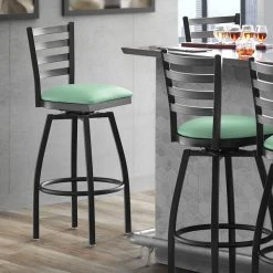 Lancaster Table & Seating Black Finish Ladder Back Swivel Bar Stool With 2 1/2" Seafoam Vinyl Padded Seat