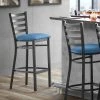 Lancaster Table & Seating Black Finish Ladder Back Bar Stool With 2 1/2" Blue Vinyl Padded Seat