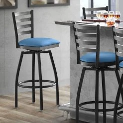 Lancaster Table & Seating Black Finish Ladder Back Swivel Bar Stool With 2 1/2" Blue Vinyl Padded Seat