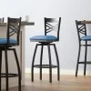 Lancaster Table & Seating Black Finish Cross Back Swivel Bar Stool With 2 1/2" Blue Vinyl Padded Seat