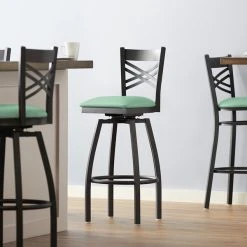 Lancaster Table & Seating Black Finish Cross Back Swivel Bar Stool With 2 1/2" Seafoam Vinyl Padded Seat