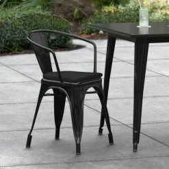 LT&S Alloy Series Lancaster Table & Seating Alloy Series Black Stackable Metal Indoor / Outdoor Industrial Cafe Arm Chair With Black Fabric Magnetic Cushion