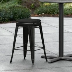 LT&S Alloy Series Lancaster Table & Seating Alloy Series Black Stackable Metal Indoor / Outdoor Industrial Cafe Counter Height Stool With Black Fabric Magnetic Cushion