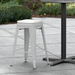 LT&S Alloy Series Lancaster Table & Seating Alloy Series Silver Stackable Metal Indoor / Outdoor Industrial Cafe Counter Height Stool With Gray Fabric Magnetic Cushion