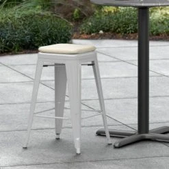 LT&S Alloy Series Lancaster Table & Seating Alloy Series Silver Stackable Metal Indoor / Outdoor Industrial Cafe Counter Height Stool With Tan Fabric Magnetic Cushion