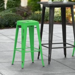 LT&S Alloy Series Lancaster Table & Seating Alloy Series Distressed Green Stackable Metal Indoor / Outdoor Industrial Barstool With Drain Hole Seat