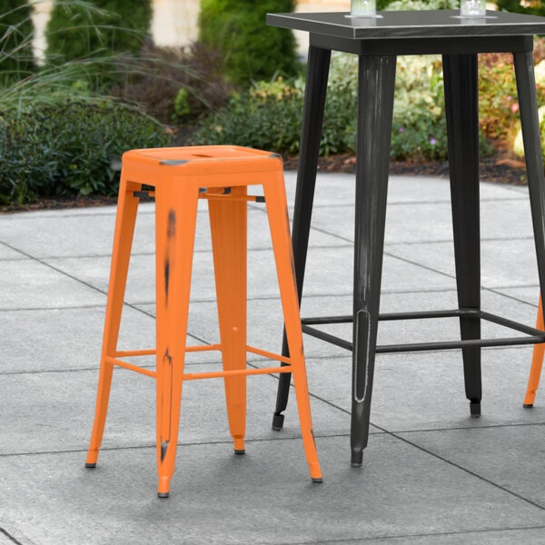 LT&S Alloy Series Lancaster Table & Seating Alloy Series Distressed Orange Stackable Metal Indoor / Outdoor Industrial Barstool With Drain Hole Seat 1 LT&S Alloy Series Lancaster Table & Seating Alloy Series Distressed Orange Stackable Metal Indoor / Outdoor Industrial Barstool With Drain Hole Seat