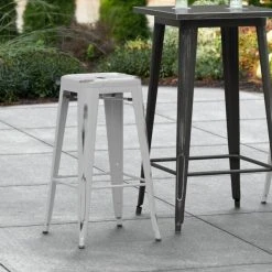 LT&S Alloy Series Lancaster Table & Seating Alloy Series Distressed Silver Stackable Metal Indoor / Outdoor Industrial Barstool With Drain Hole Seat