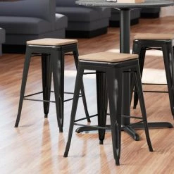 LT&S Alloy Series Lancaster Table & Seating Alloy Series Distressed Black Metal Indoor Industrial Cafe Counter Height Stool With Natural Wood Seat