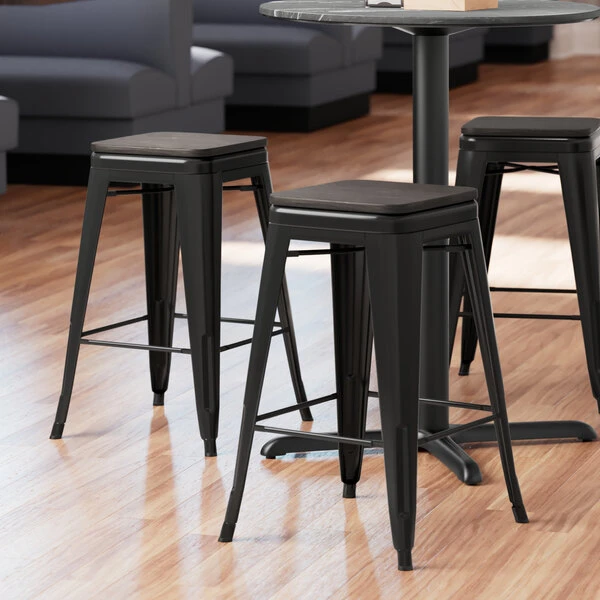LT&S Alloy Series Lancaster Table & Seating Alloy Series Black Metal Indoor Industrial Cafe Counter Height Stool With Black Wood Seat 1 LT&S Alloy Series Lancaster Table & Seating Alloy Series Black Metal Indoor Industrial Cafe Counter Height Stool With Black Wood Seat