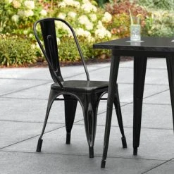 LT&S Alloy Series Lancaster Table & Seating Alloy Series Distressed Black Metal Indoor / Outdoor Industrial Cafe Chair With Vertical Slat Back And Drain Hole Seat