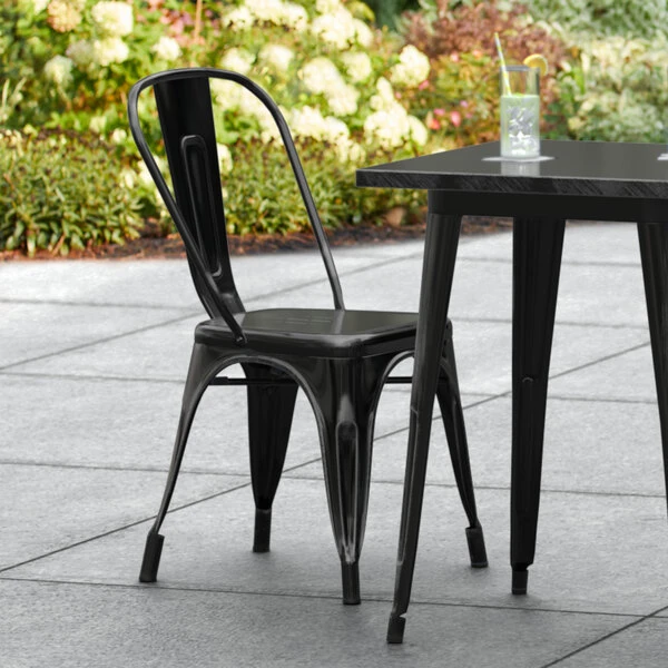 LT&S Alloy Series Lancaster Table & Seating Alloy Series Distressed Black Metal Indoor / Outdoor Industrial Cafe Chair With Vertical Slat Back And Drain Hole Seat 1 LT&S Alloy Series Lancaster Table & Seating Alloy Series Distressed Black Metal Indoor / Outdoor Industrial Cafe Chair With Vertical Slat Back And Drain Hole Seat
