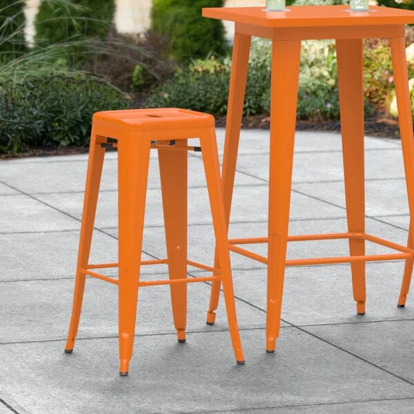 LT&S Alloy Series Lancaster Table & Seating Alloy Series Orange Stackable Metal Indoor / Outdoor Industrial Barstool With Drain Hole Seat 1 LT&S Alloy Series Lancaster Table & Seating Alloy Series Orange Stackable Metal Indoor / Outdoor Industrial Barstool With Drain Hole Seat
