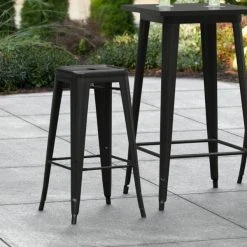 LT&S Alloy Series Lancaster Table & Seating Alloy Series Black Stackable Metal Indoor / Outdoor Industrial Barstool With Drain Hole Seat