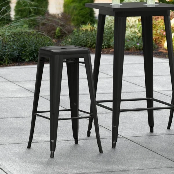 LT&S Alloy Series Lancaster Table & Seating Alloy Series Black Stackable Metal Indoor / Outdoor Industrial Barstool With Drain Hole Seat 1 LT&S Alloy Series Lancaster Table & Seating Alloy Series Black Stackable Metal Indoor / Outdoor Industrial Barstool With Drain Hole Seat
