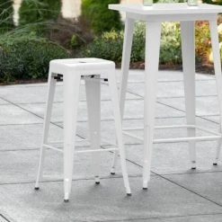 LT&S Alloy Series Lancaster Table & Seating Alloy Series White Stackable Metal Indoor / Outdoor Industrial Barstool With Drain Hole Seat