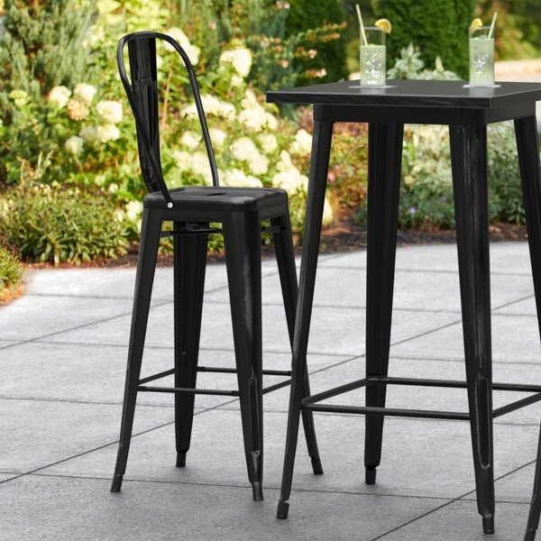 LT&S Alloy Series Lancaster Table & Seating Alloy Series Distressed Black Metal Indoor / Outdoor Industrial Cafe Barstool With Vertical Slat Back And Drain Hole Seat 1 LT&S Alloy Series Lancaster Table & Seating Alloy Series Distressed Black Metal Indoor / Outdoor Industrial Cafe Barstool With Vertical Slat Back And Drain Hole Seat