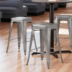 LT&S Alloy Series Lancaster Table & Seating Alloy Series Clear Coated Stackable Metal Indoor Industrial Cafe Counter Height Stool With Drain Hole Seat