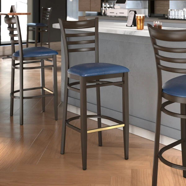 LT&S Spartan Series Lancaster Table & Seating Spartan Series Bar Height Metal Ladder Back Chair With Walnut Wood Grain Finish And Navy Vinyl Seat 1 LT&S Spartan Series Lancaster Table & Seating Spartan Series Bar Height Metal Ladder Back Chair With Walnut Wood Grain Finish And Navy Vinyl Seat