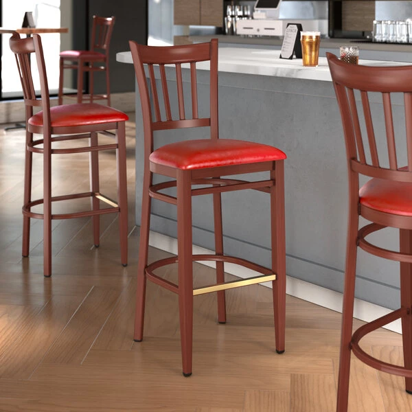 LT&S Spartan Series Lancaster Table & Seating Spartan Series Bar Height Metal Slat Back Chair With Mahogany Wood Grain Finish And Red Vinyl Seat 1 LT&S Spartan Series Lancaster Table & Seating Spartan Series Bar Height Metal Slat Back Chair With Mahogany Wood Grain Finish And Red Vinyl Seat