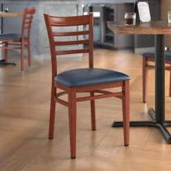 LT&S Spartan Series Lancaster Table & Seating Spartan Series Metal Ladder Back Chair With Mahogany Wood Grain Finish And Navy Vinyl Seat