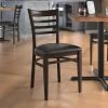 LT&S Spartan Series Lancaster Table & Seating Spartan Series Metal Ladder Back Chair With Walnut Wood Grain Finish And Black Vinyl Seat