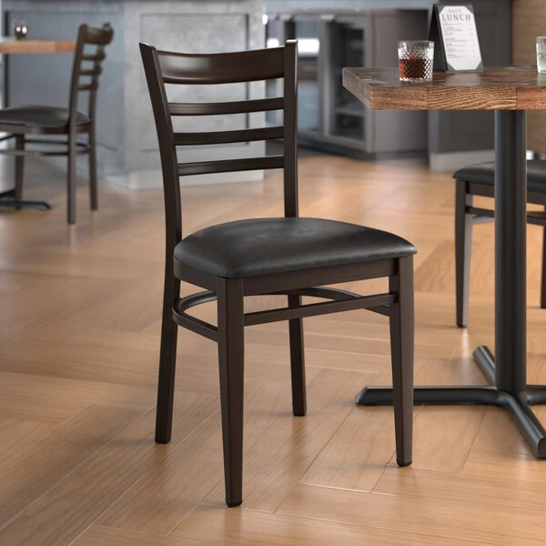 LT&S Spartan Series Lancaster Table & Seating Spartan Series Metal Ladder Back Chair With Walnut Wood Grain Finish And Black Vinyl Seat 1 LT&S Spartan Series Lancaster Table & Seating Spartan Series Metal Ladder Back Chair With Walnut Wood Grain Finish And Black Vinyl Seat