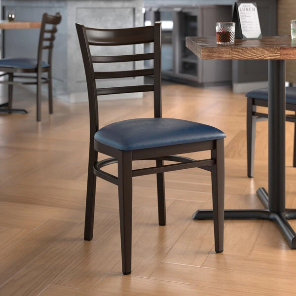 LT&S Spartan Series Lancaster Table & Seating Spartan Series Metal Ladder Back Chair With Walnut Wood Grain Finish And Navy Vinyl Seat 1 LT&S Spartan Series Lancaster Table & Seating Spartan Series Metal Ladder Back Chair With Walnut Wood Grain Finish And Navy Vinyl Seat